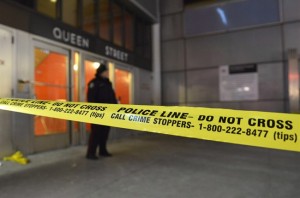 A police officer attends the scene at the Queen Street subway station entrance in Toronto on Dec. 13, 2013, in Ottawa. THE CANADIAN PRESS/Doug Ives 