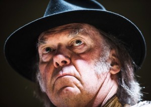 Singer Neil Young speaks during a press conference for the "Honour the Treaties" tour, a series benefit concerts being held to raise money for legal fight against the expansion of the Athabasca oilsands in northern Alberta and other similar projects, in Toronto, Sunday January 12, 2014. THE CANADIAN PRESS/Mark Blinch 