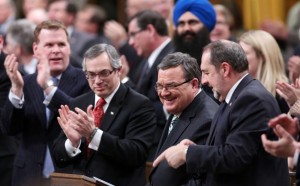 Minister of Finance Jim Flaherty is applauded as he arrives to table the budget in the House of Commons on Parliament Hill in Ottawa on Tuesday, February 11, 2014. THE CANADIAN PRESS/Fred Chartrand 