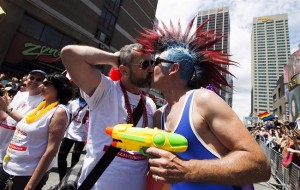 Paraders kiss during the 33rd annual Pride Parade in Toronto on June 30, 2013. THE CANADIAN PRESS/Michelle Siu 