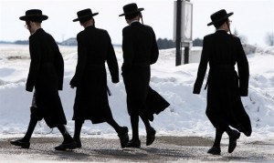 Members of the Lev Tahor ultra-orthodox Jewish sect walk down a street in Chatham, Ont., Wednesday, March 5, 2014. THE CANADIAN PRESS/Dave Chidley 