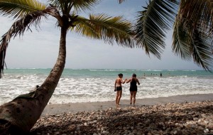 In this June 28, 2021 photo, tourists walk on the shore of the Raymond les bains beach in Jacmel, Haiti. Although its sandy white beaches may rival any country in the Caribbean, Haiti's troubled past has set the country far behind its neighbours when it comes to tourism. THE CANADIAN PRESS/AP, Dieu Nalio Chery  