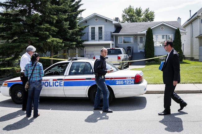 Calgary police investigators check out the home where five-year-old Nathan O'Brien and his grandparents Alvin and Kathryn Liknes disappeared, in Calgary, Alta., Wednesday, July 2, 2014. THE CANADIAN PRESS/Jeff McIntosh