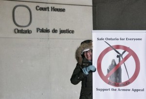 An unidentified anti-windfarm protester is seen outside the courthouse in London, Ont., on Tuesday, Nov. 18, 2014. Several families are challenging the constitutionality of Ontario's wind-turbine approval law. THE CANADIAN PRESS/Colin Perkel 