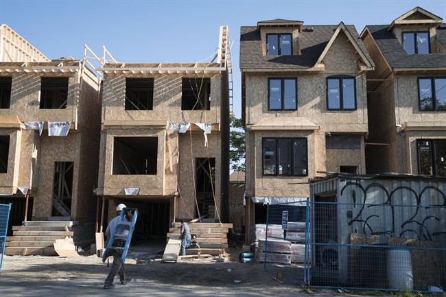 Houses are shown under construction in Toronto on Friday, June 26, 2015. Canada Mortgage and Housing Corp. expects the country's housing markets to moderate. THE CANADIAN PRESS/Graeme Roy
