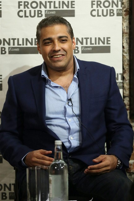 Former Al Jazeera bureau chief Mohamed Fahmy smiles during a talk at the Frontline Club in London, Wednesday Oct. 7, 2015. Fahmy, detained on terror-related charges in Egypt, arrived in Toronto on Sunday. THE CANADIAN PRESS/AP/Tim Ireland 